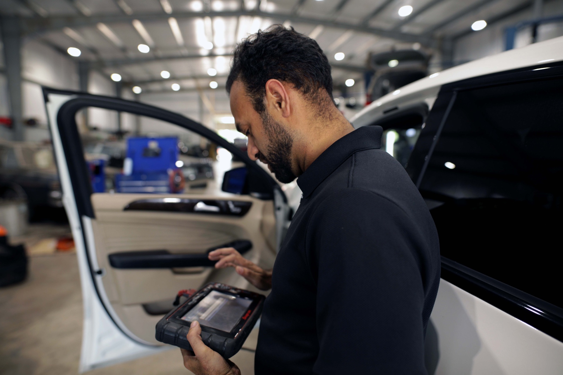 Technician running diagnostics at Derby City Tire & Auto